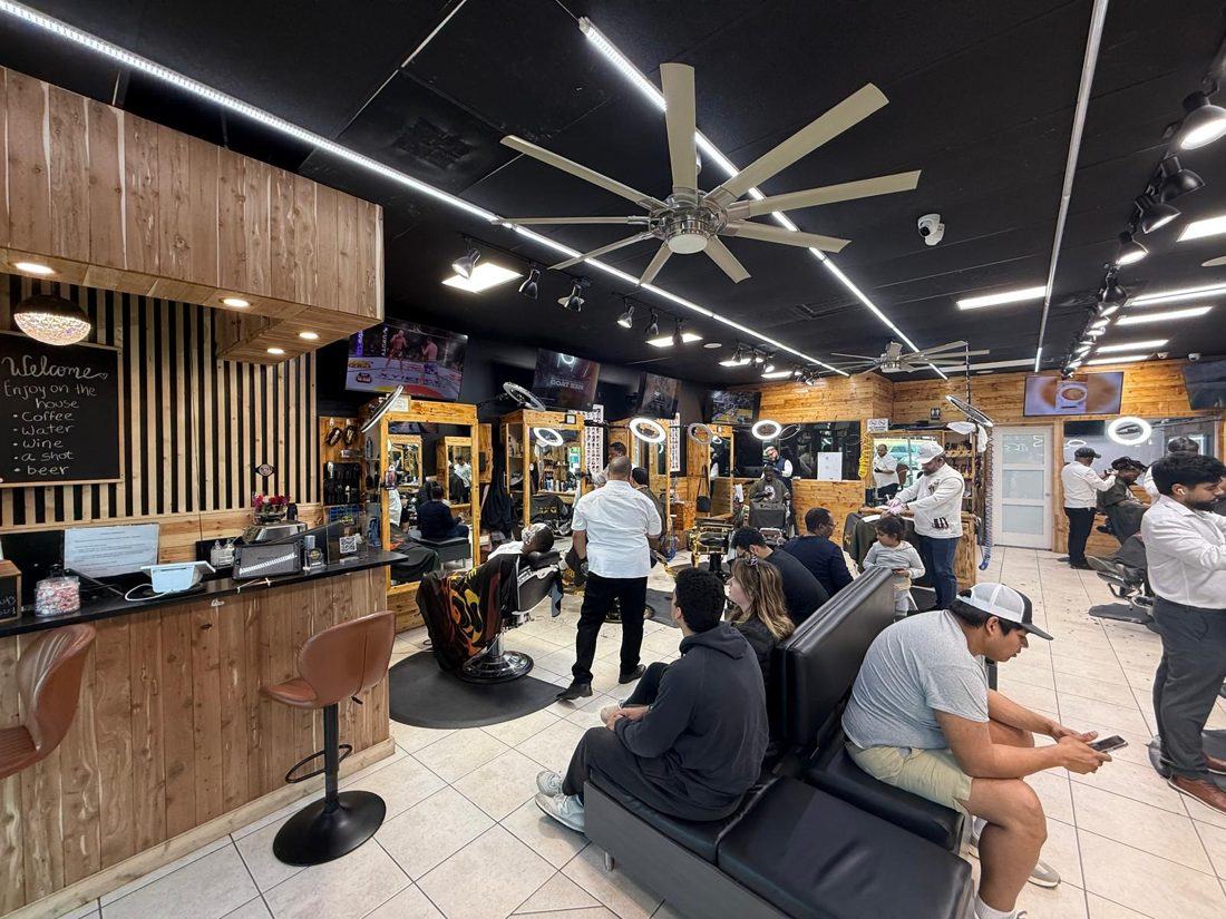 Inside D'Kache Barbershop & Salon in Charlotte: barbers at work and clients waiting